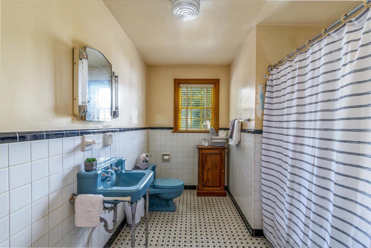 2510 Tillett Road Southwest Roanoke, VA 24015 - Photo 14 of 27 a bathroom with a sink a toilet and mirror