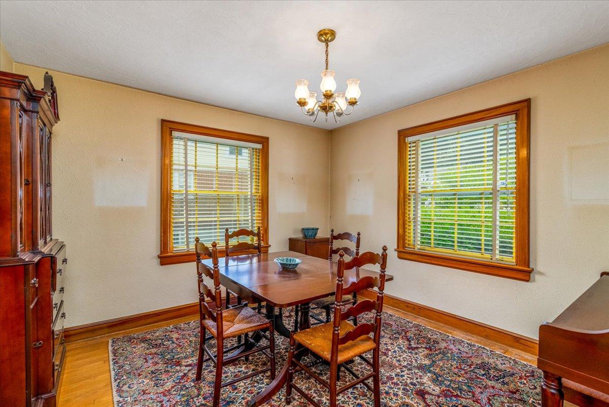 2510 Tillett Road Southwest Roanoke, VA 24015 - Photo 7 of 27 a dining room with chandelier and wooden floor