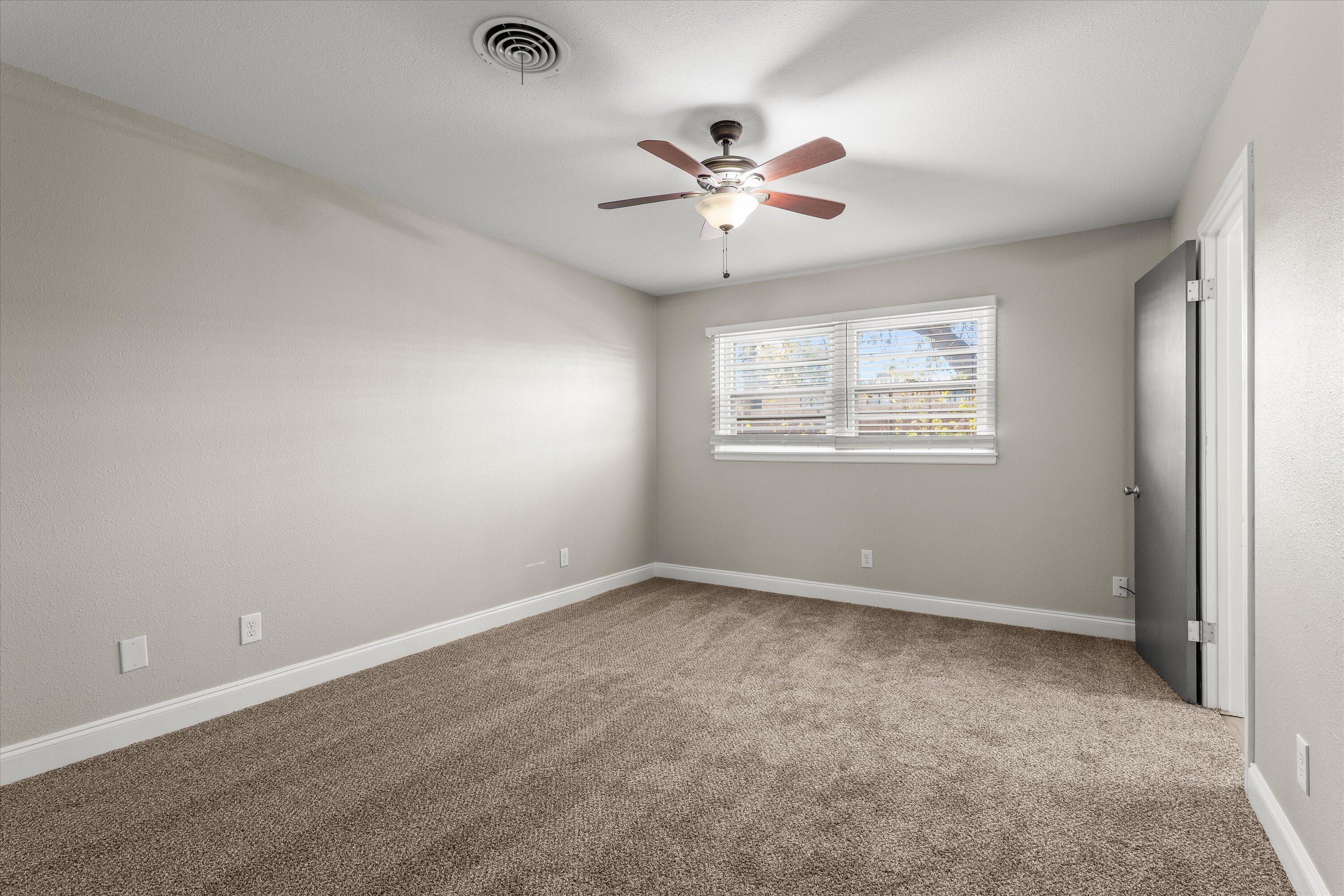 3809 49th Street Lubbock, TX 79413 - Photo 11 of 24 an empty room with windows and fan