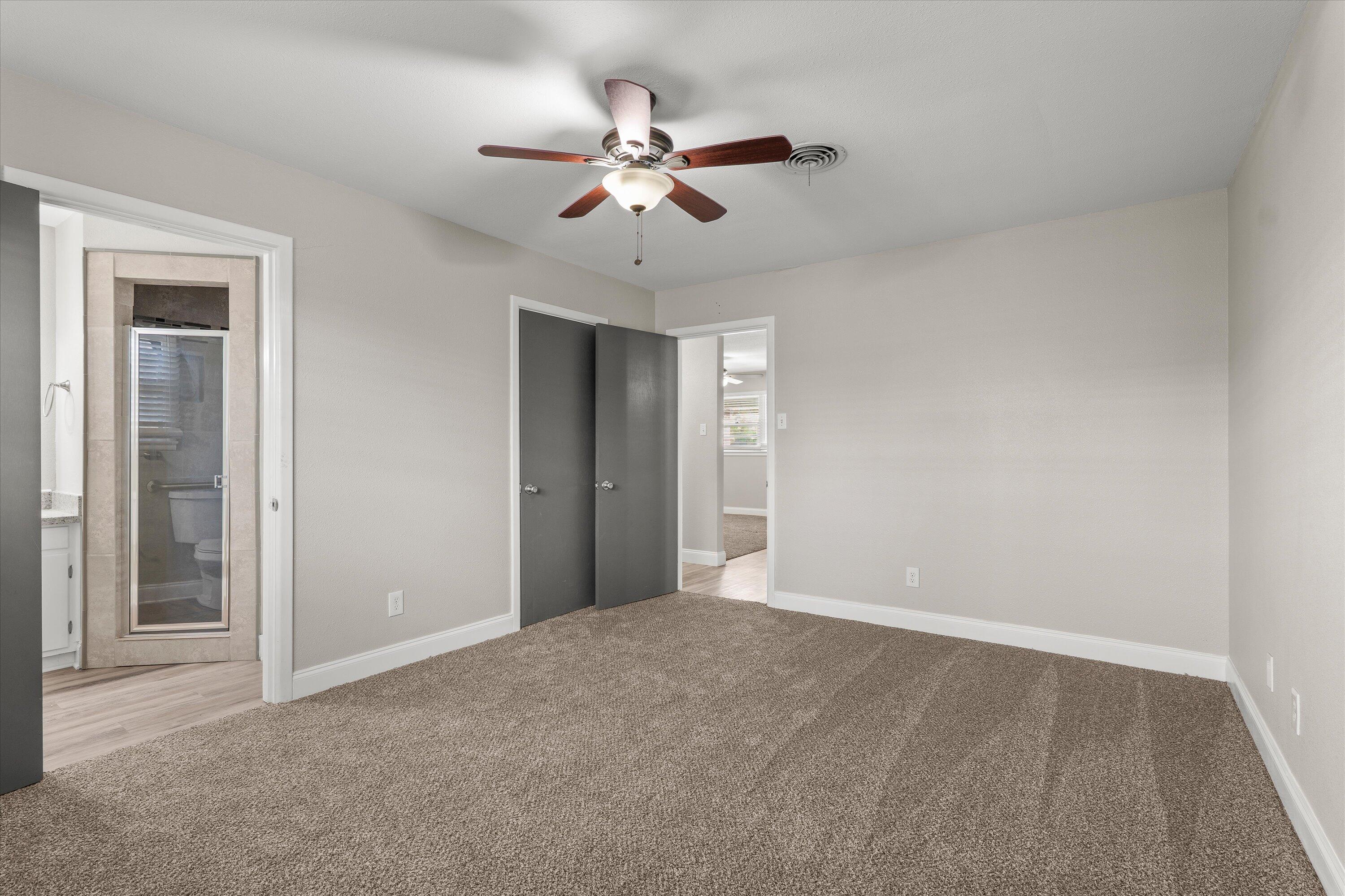 3809 49th Street Lubbock, TX 79413 - Photo 12 of 24 a view of an empty room with a ceiling fan