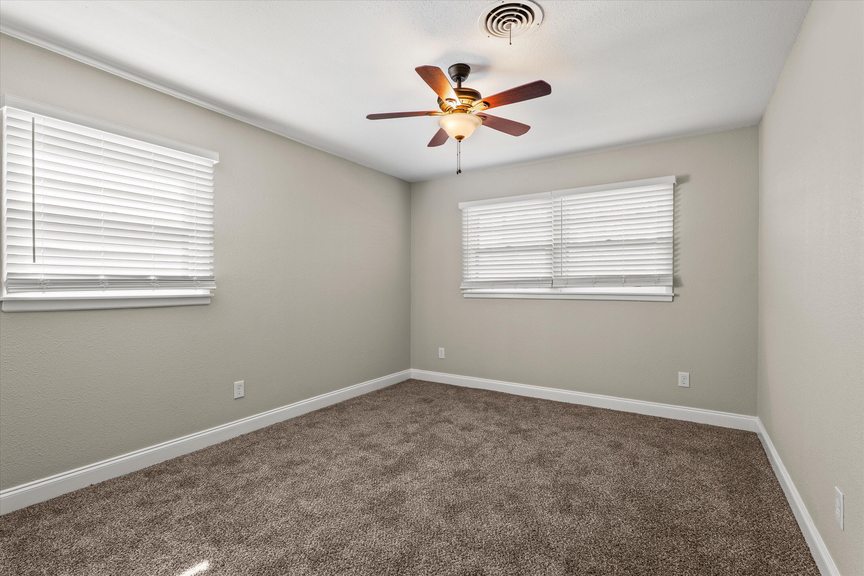 3809 49th Street Lubbock, TX 79413 - Photo 14 of 24 an empty room with window and ceiling fan