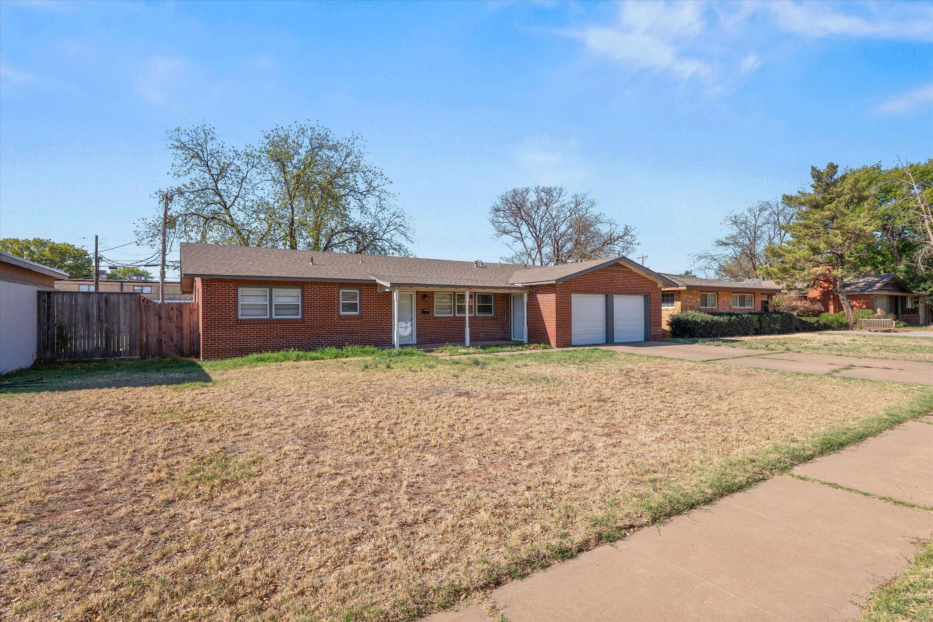 3809 49th Street Lubbock, TX 79413 - Photo 15 of 24 a front view of a house with a garden
