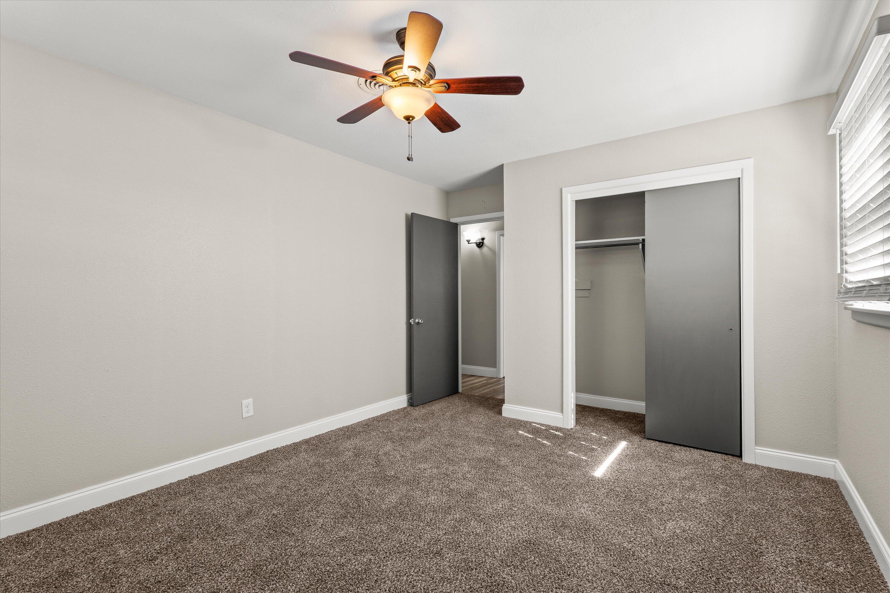 3809 49th Street Lubbock, TX 79413 - Photo 16 of 24 an empty room with closet and windows