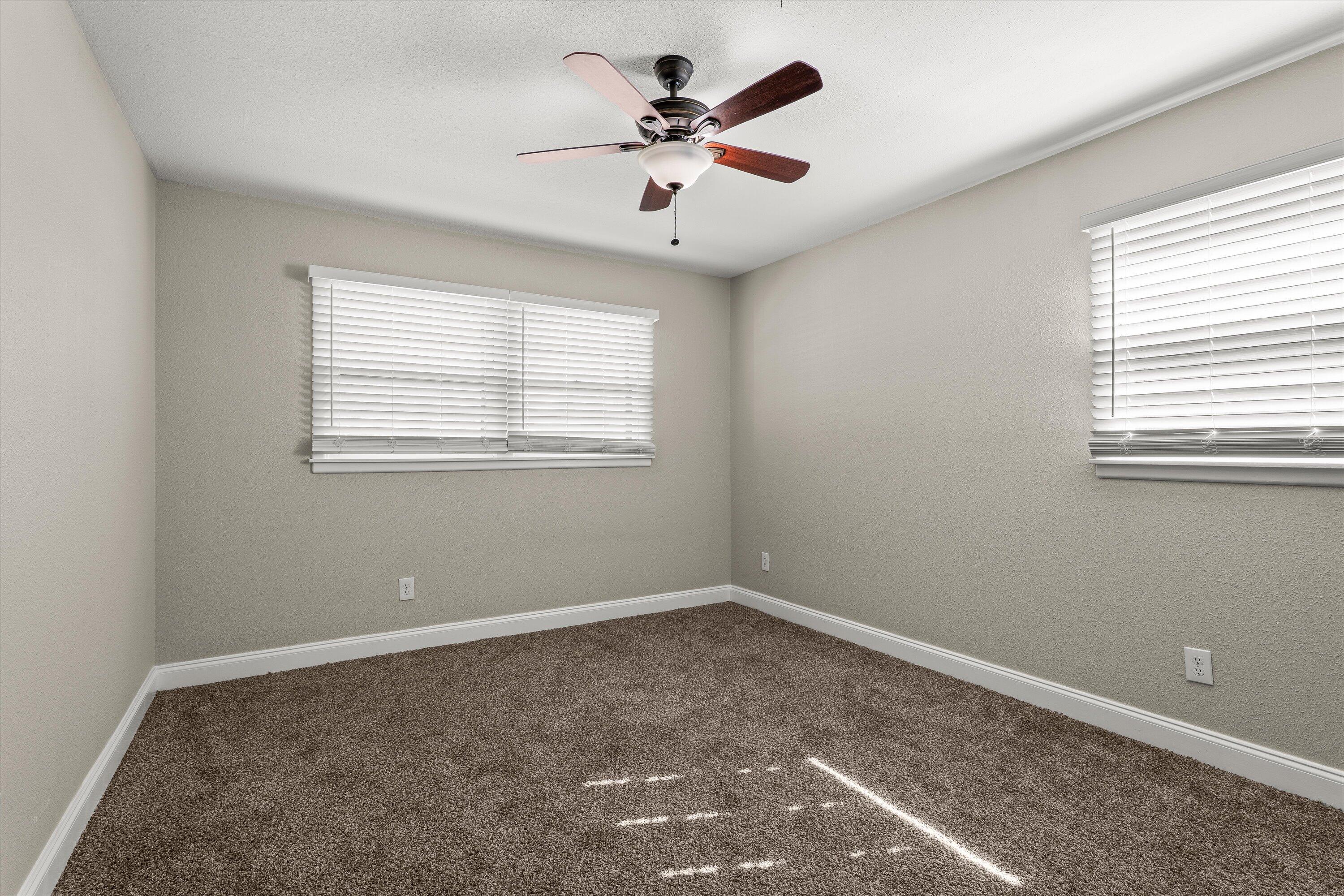 3809 49th Street Lubbock, TX 79413 - Photo 20 of 24 a view of a livingroom with a ceiling fan and window