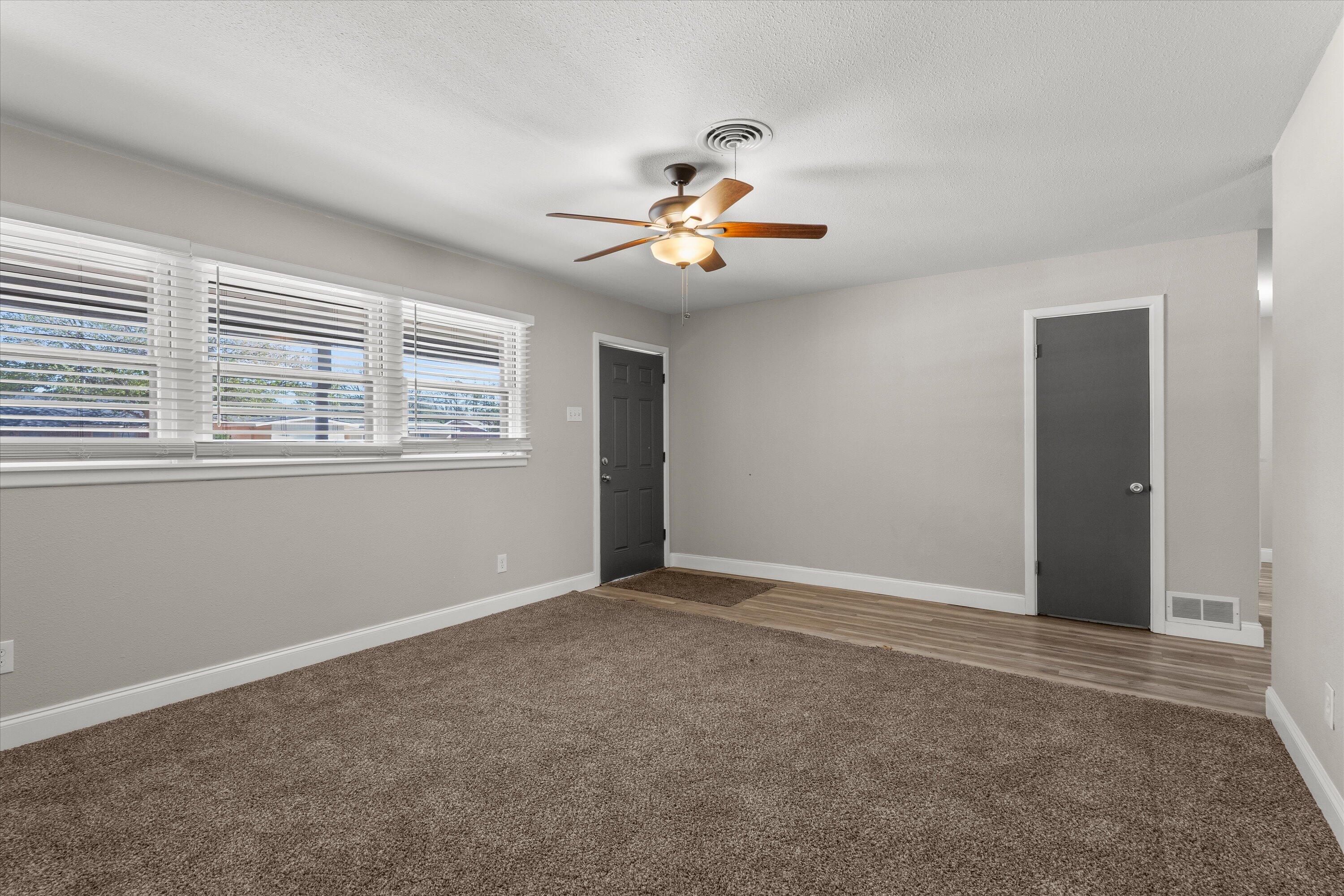 3809 49th Street Lubbock, TX 79413 - Photo 2 of 24 a view of an empty room with a window