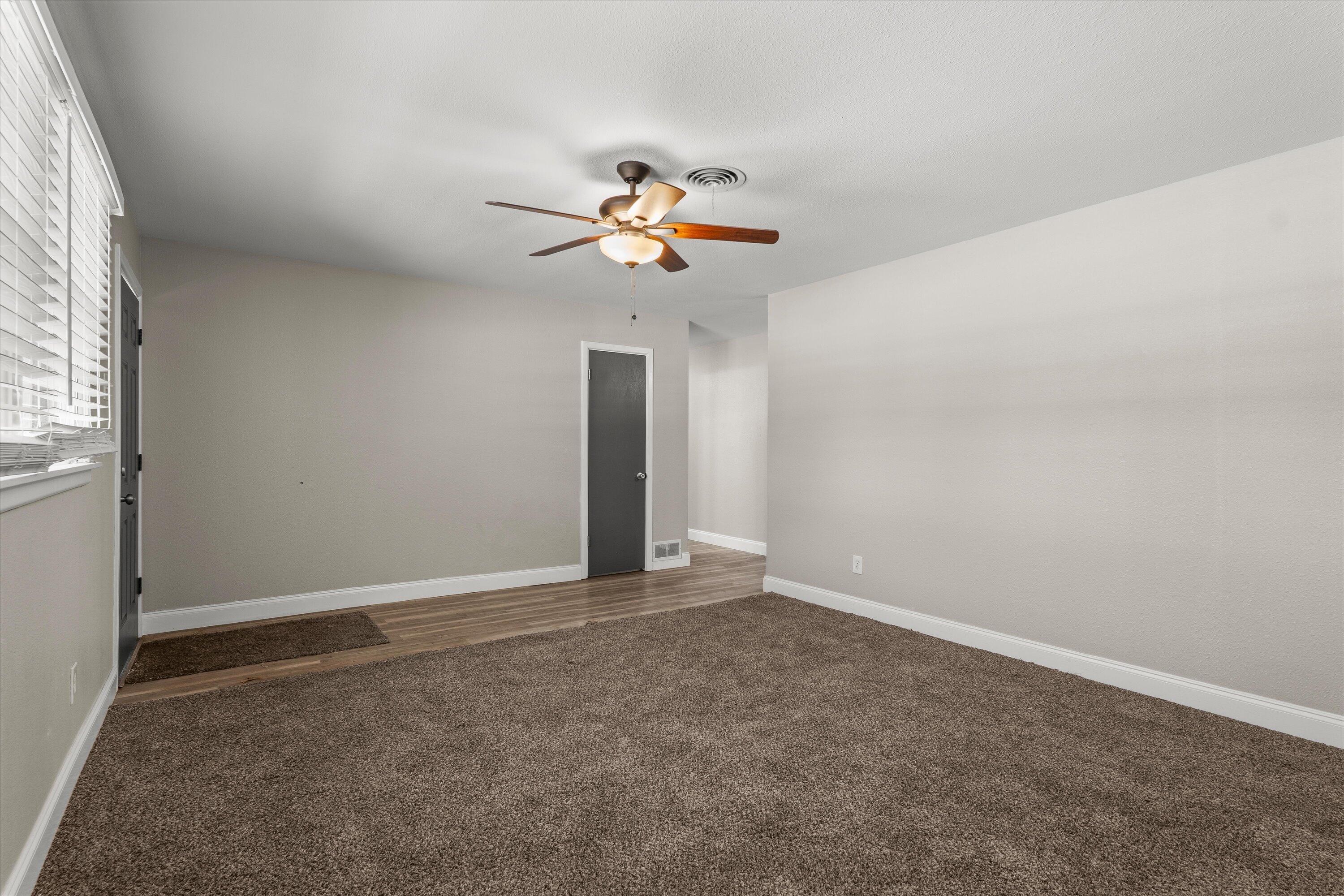3809 49th Street Lubbock, TX 79413 - Photo 4 of 24 an empty room with a window and a ceiling fan