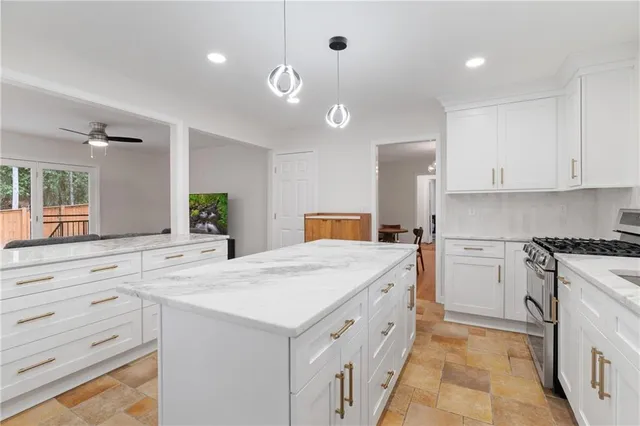 a kitchen that has a lot of cabinets in it and wooden floors