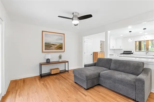 a living room with furniture and kitchen view