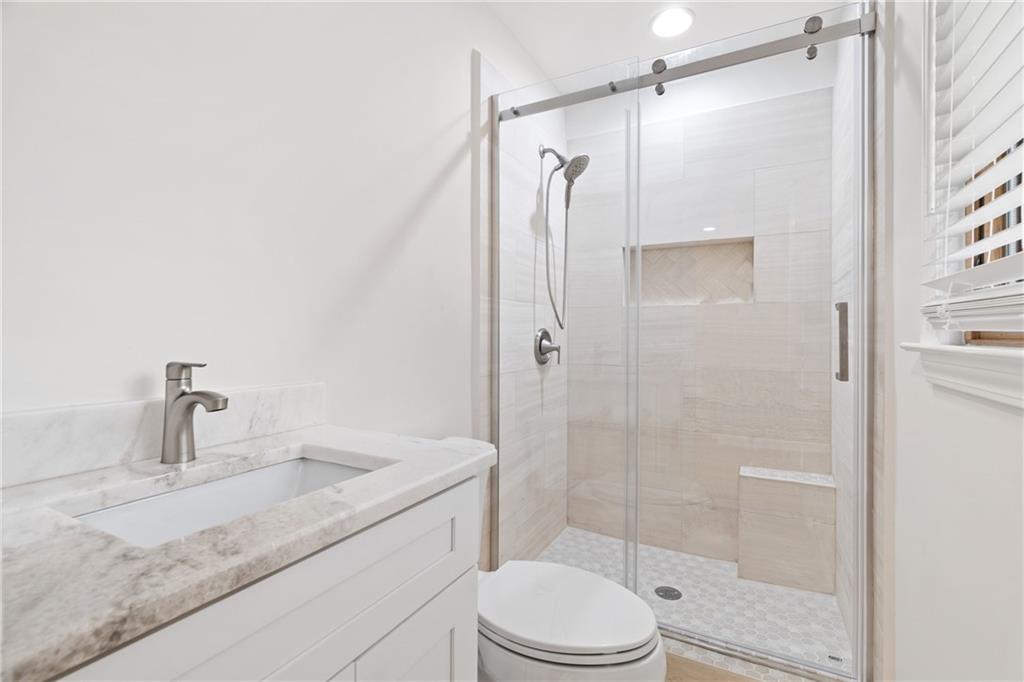 2608 Laurelwood Road Atlanta, GA 30360 - Photo 16 of 45 a bathroom with a granite countertop sink toilet and shower