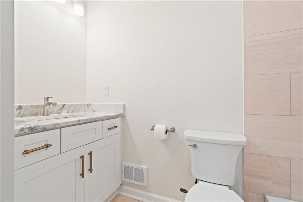 2608 Laurelwood Road Atlanta, GA 30360 - Photo 18 of 45 a bathroom with a granite countertop toilet and sink