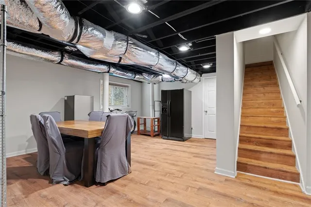 a dining room with furniture and wooden floor