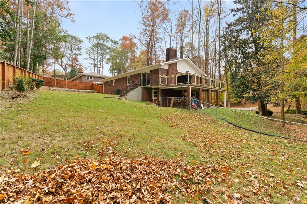 2608 Laurelwood Road Atlanta, GA 30360 - Photo 32 of 45 a view of a large house with a big yard and large trees