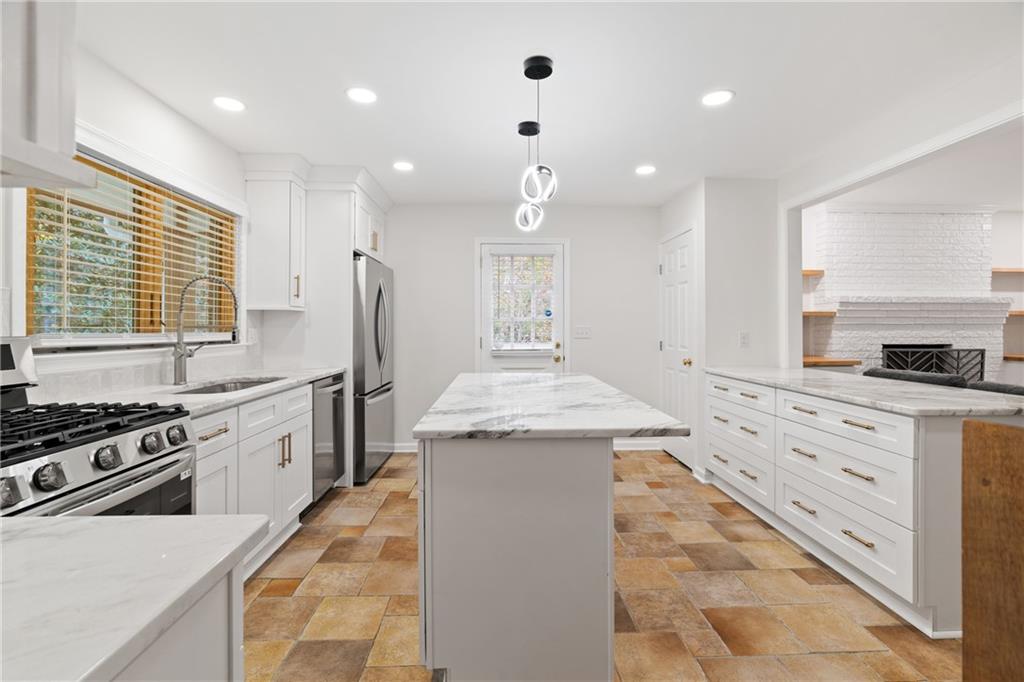 2608 Laurelwood Road Atlanta, GA 30360 - Photo 8 of 45 a kitchen with a stove sink and cabinets
