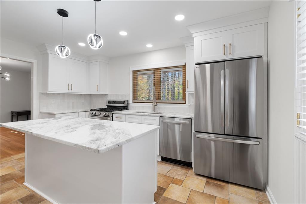 2608 Laurelwood Road Atlanta, GA 30360 - Photo 10 of 45 a kitchen with stainless steel appliances granite countertop a refrigerator a sink a stove a microwave and a refrigerator