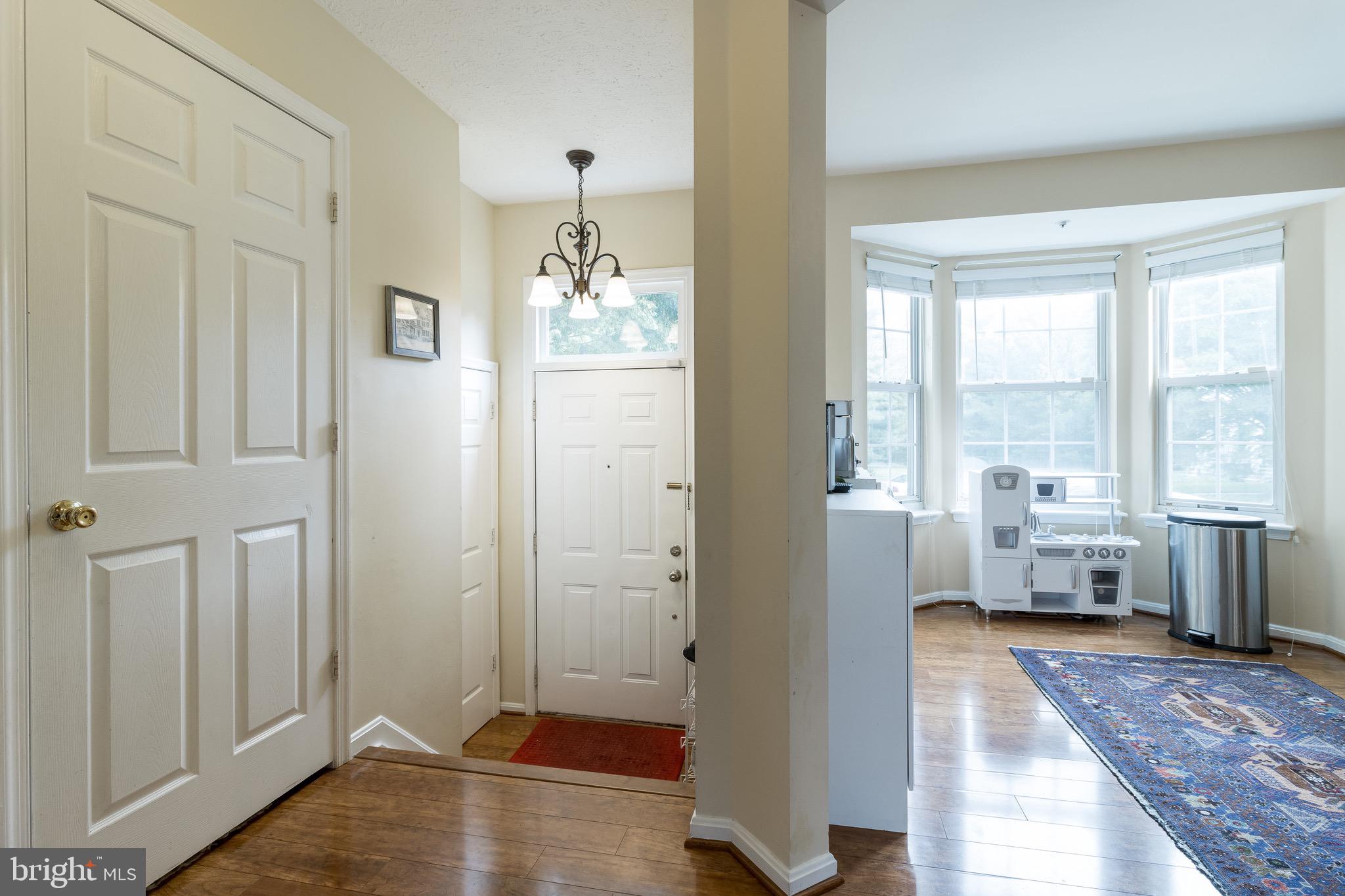 Entry featuring half bath and closet