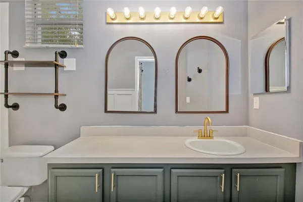 a bathroom with a toilet sink and vanity