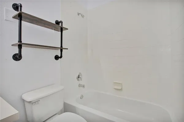 a bathroom with a sink toilet and a mirror