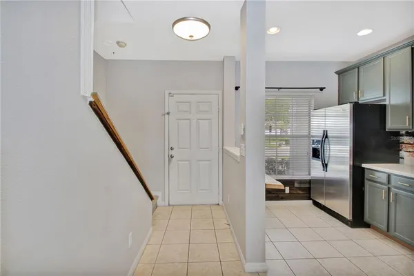 a view of empty room with window and chandelier