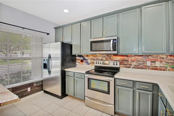 a kitchen with stainless steel appliances granite countertop a sink and a stove