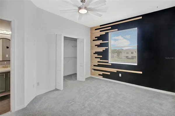 a view of an empty room with closet area
