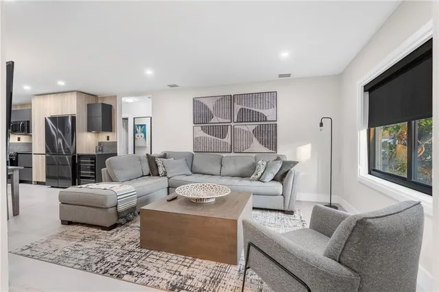 a kitchen with kitchen island a counter space a sink appliances and cabinets