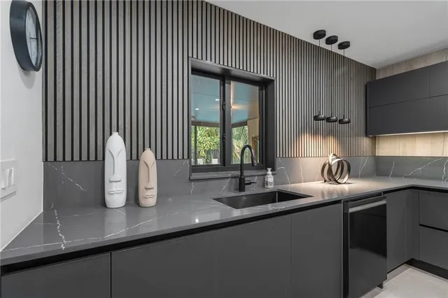 a kitchen with kitchen island stainless steel appliances a sink stove and refrigerator