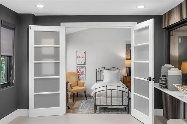 a bedroom with a bed and a mirror