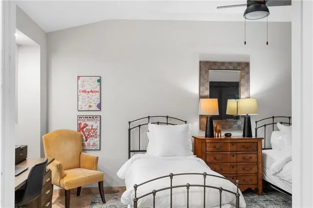 a spacious bedroom with a bed a couch and dresser