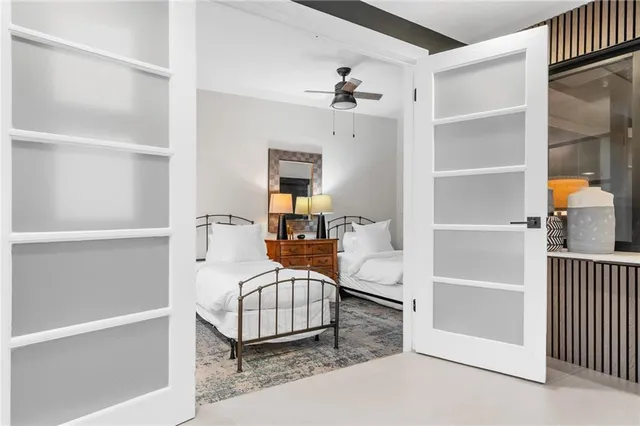 a view of living room filled with furniture and large windows