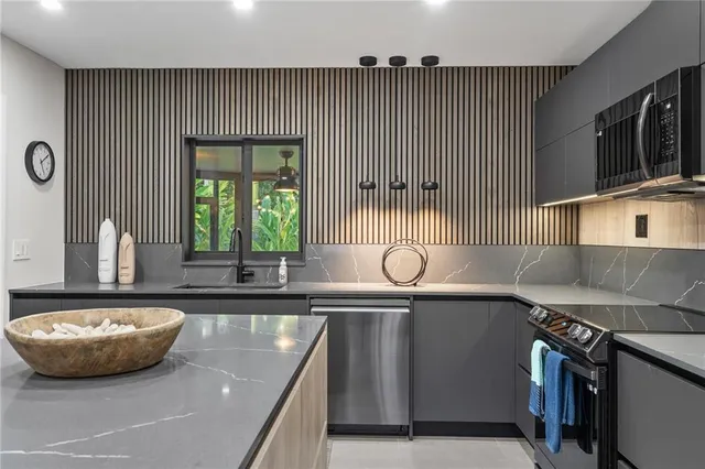 a bedroom with a bed and a flat tv screen on dresser