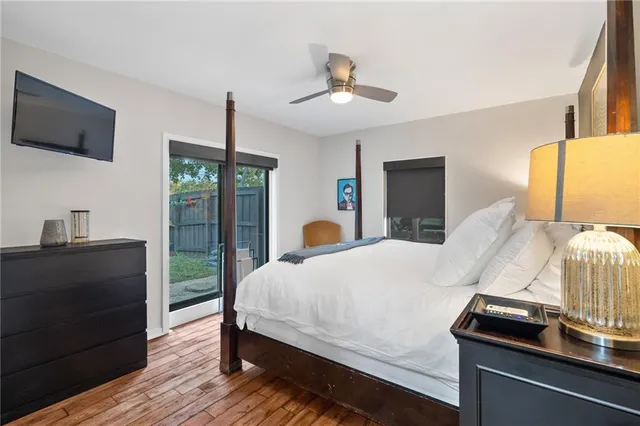 a bedroom with a bed and a lamp on dresser