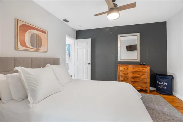 a bedroom with two beds and painting on the wall