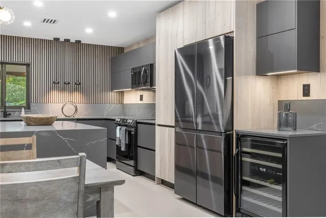 a front view of house with yard and trees around