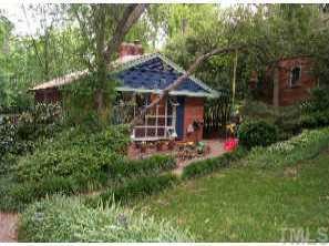 a view of a house with a backyard and garden