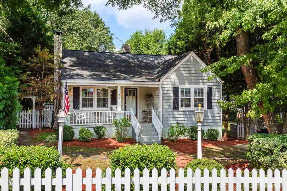403 Pershing Road Raleigh, NC 27608 - Photo 1 of 20 a front view of a house with a yard and potted plants