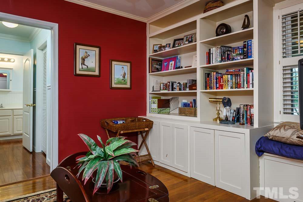 403 Pershing Road Raleigh, NC 27608 - Photo 16 of 20 a living room with furniture cabinets and a book shelf