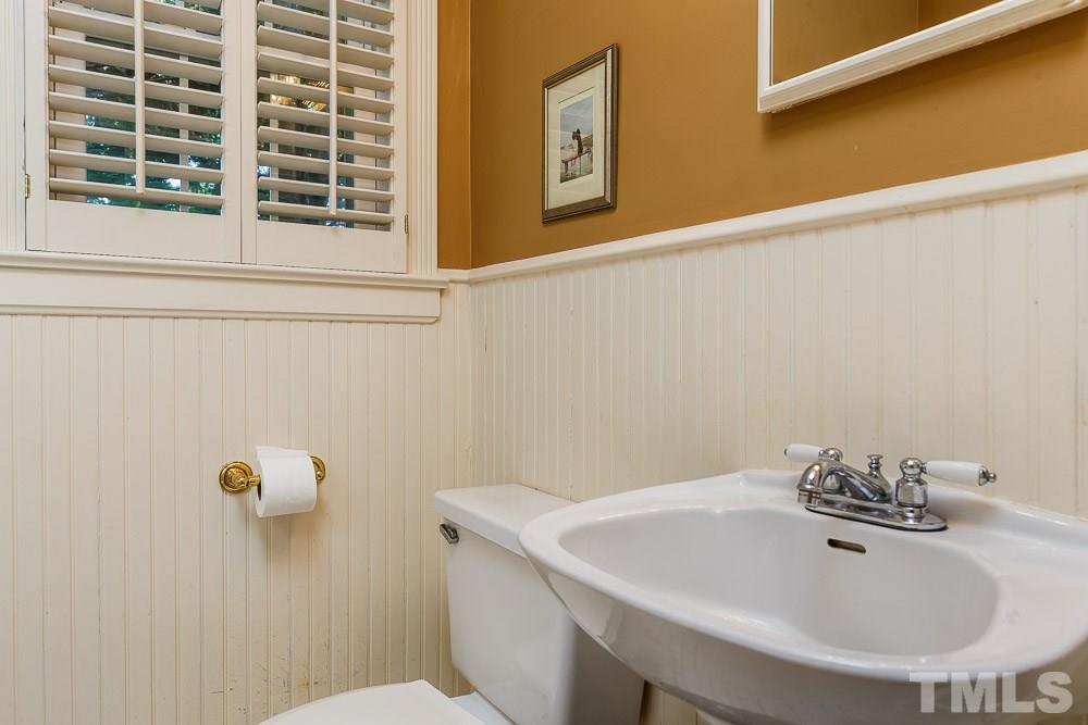 403 Pershing Road Raleigh, NC 27608 - Photo 17 of 20 a bathroom with a sink and a toilet