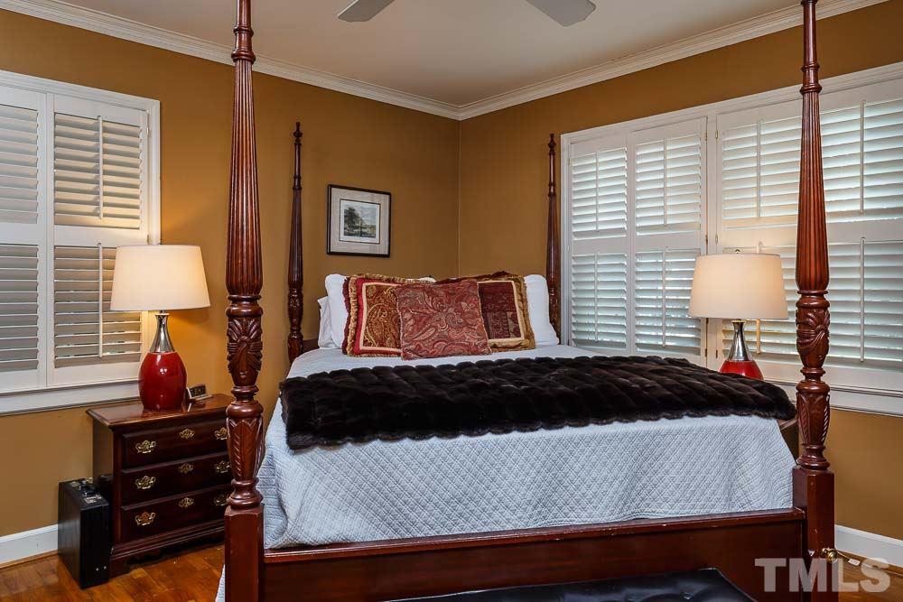 403 Pershing Road Raleigh, NC 27608 - Photo 18 of 20 a bedroom with a bed and a lamp on dresser