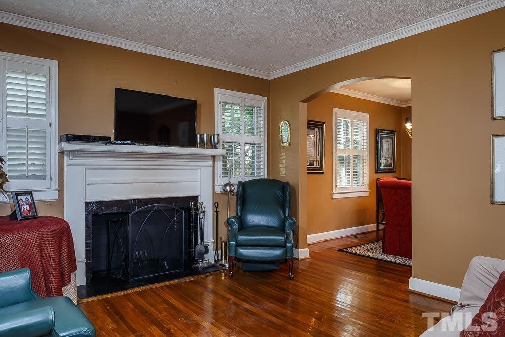 403 Pershing Road Raleigh, NC 27608 - Photo 7 of 20 a living room with furniture and a fireplace