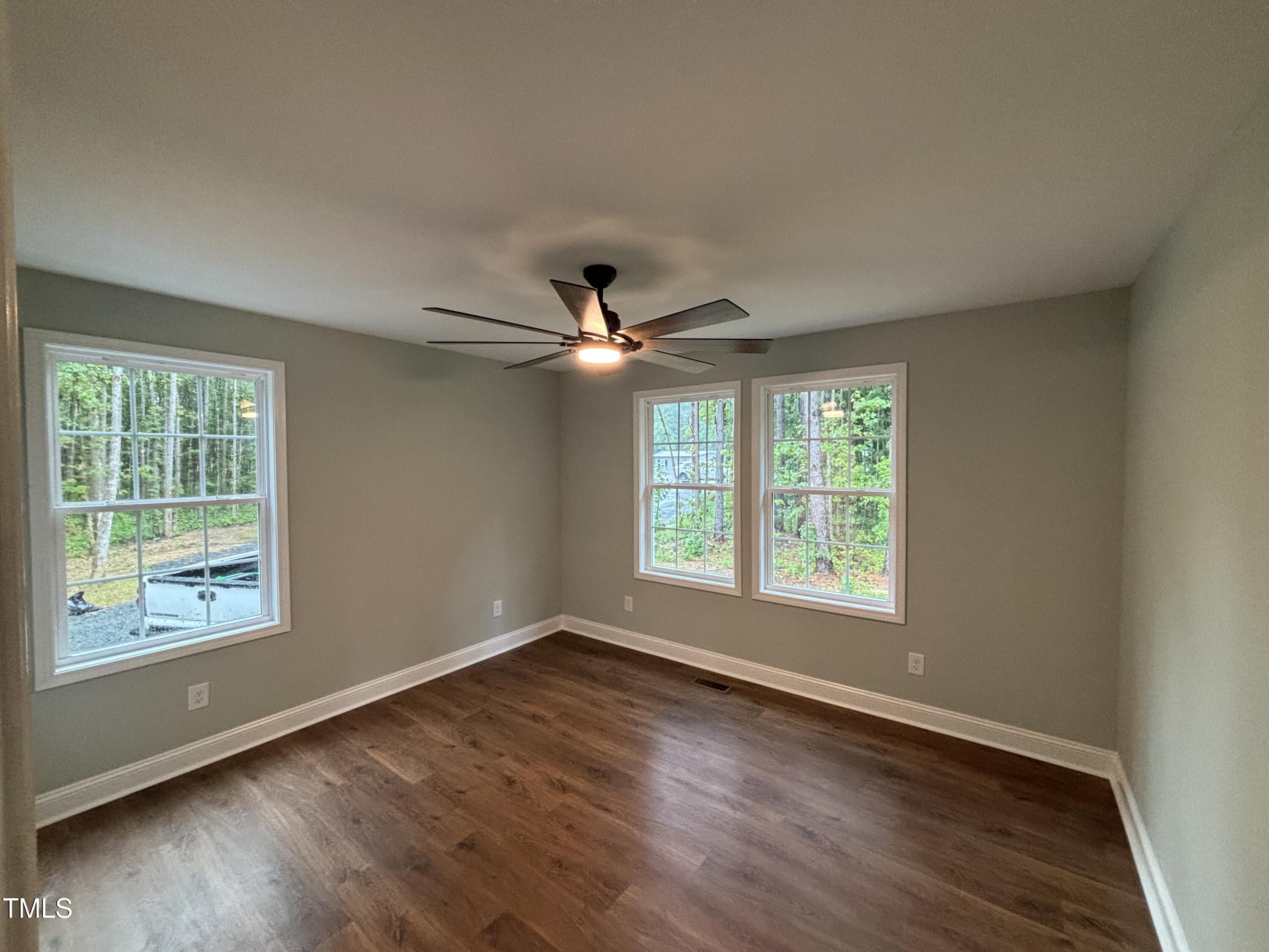 2665 Bodie Currin Road Oxford, NC 27565 - Photo 11 of 26 a view of an empty room with wooden floor and a window