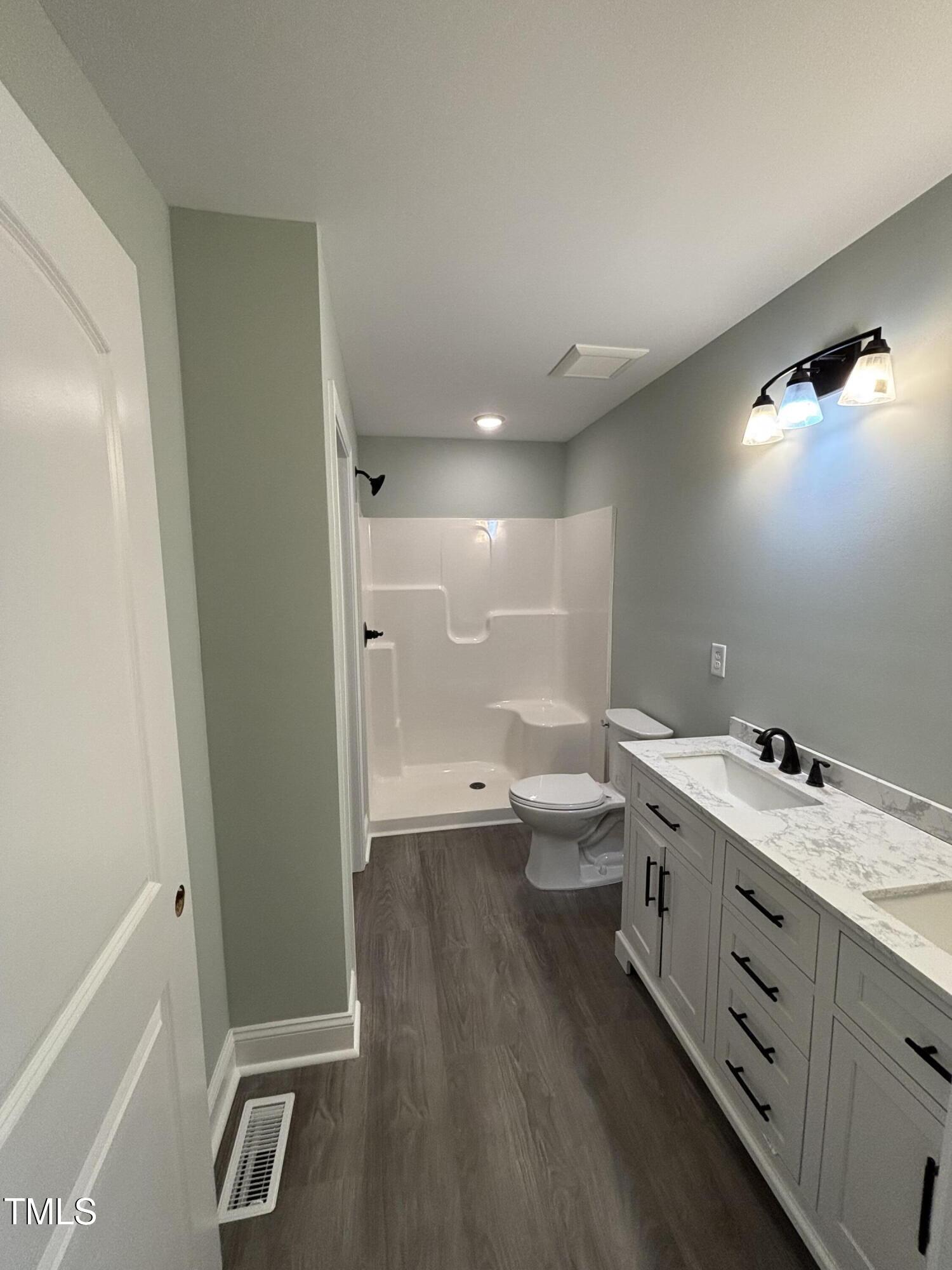 2665 Bodie Currin Road Oxford, NC 27565 - Photo 12 of 26 a bathroom with a toilet sink and mirror