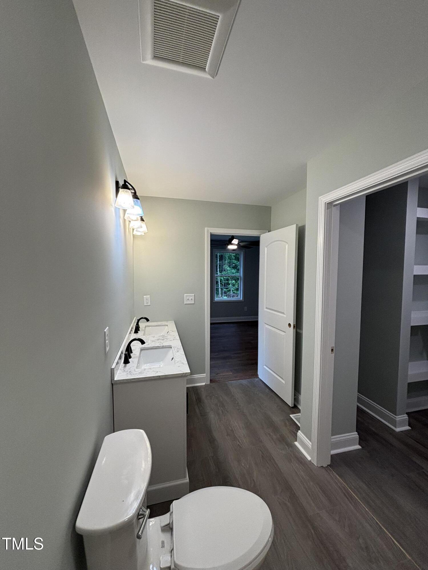 2665 Bodie Currin Road Oxford, NC 27565 - Photo 13 of 26 a bathroom with a toilet a sink and mirror