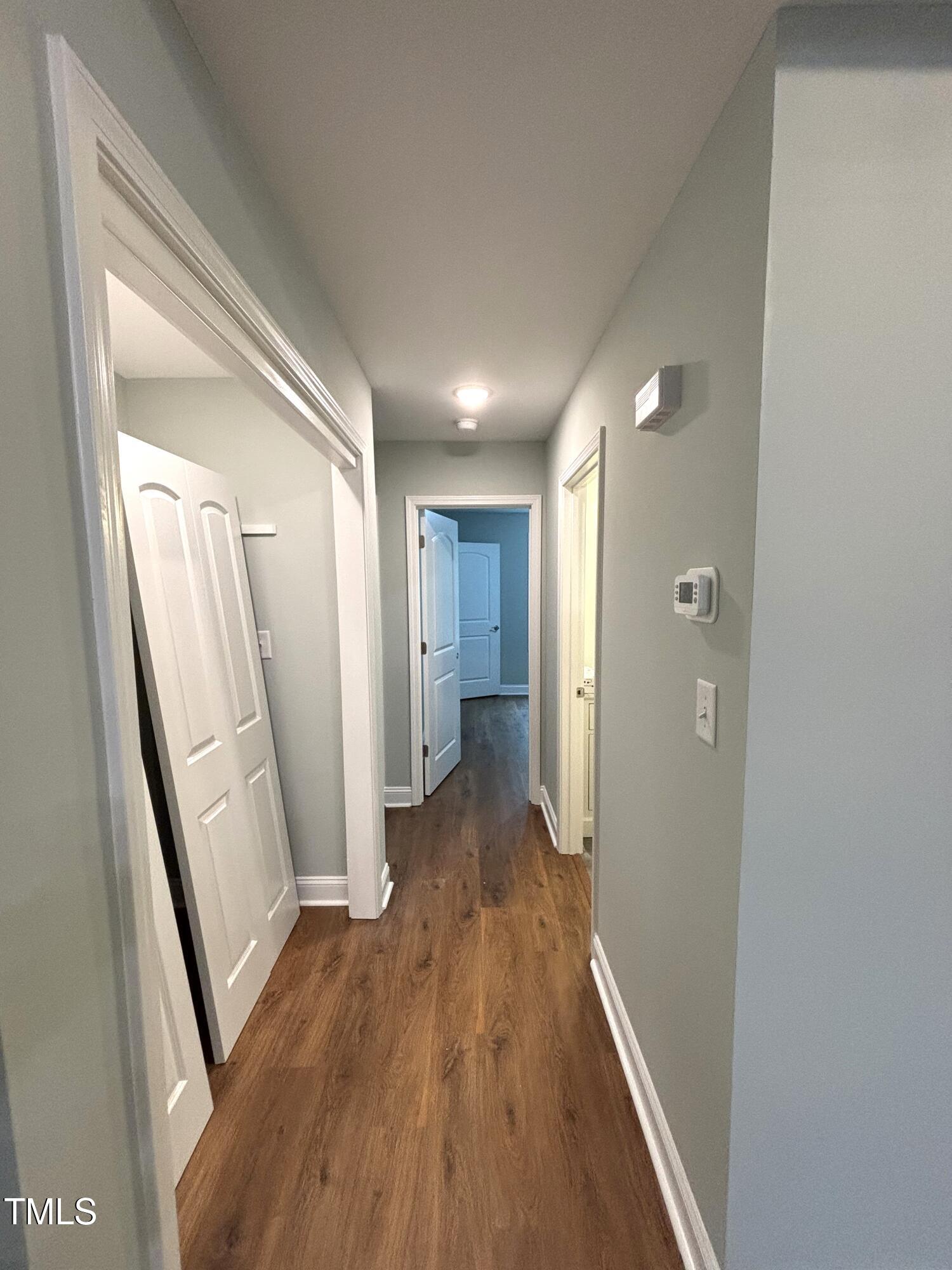2665 Bodie Currin Road Oxford, NC 27565 - Photo 15 of 26 a view of a hallway with wooden floor and staircase