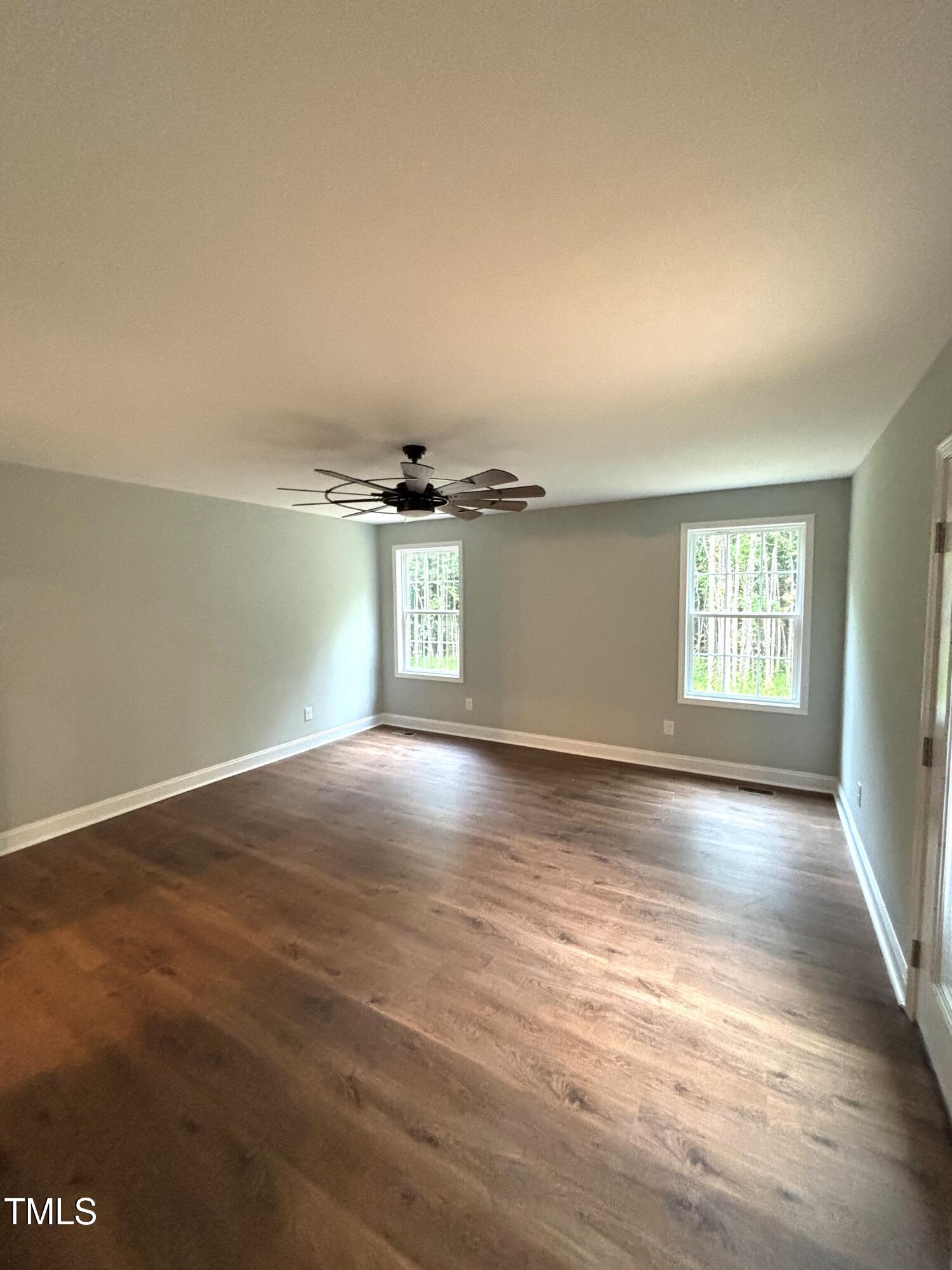 2665 Bodie Currin Road Oxford, NC 27565 - Photo 16 of 26 an empty room with wooden floor and windows