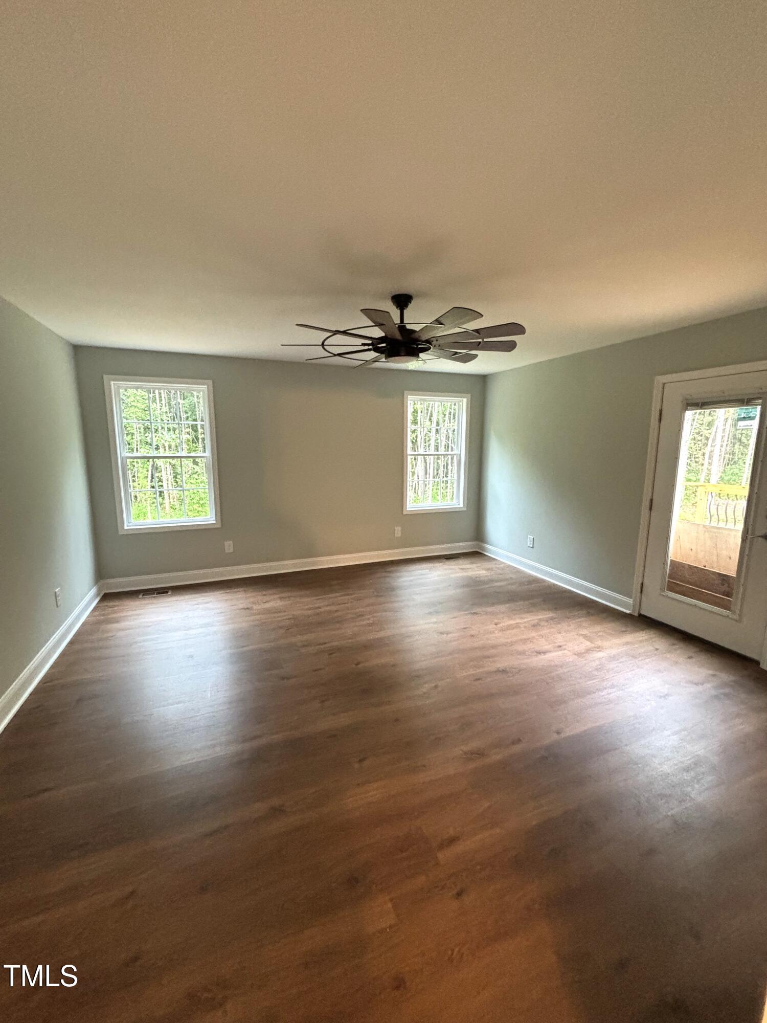 2665 Bodie Currin Road Oxford, NC 27565 - Photo 17 of 26 a view of an empty room with a window and wooden floor