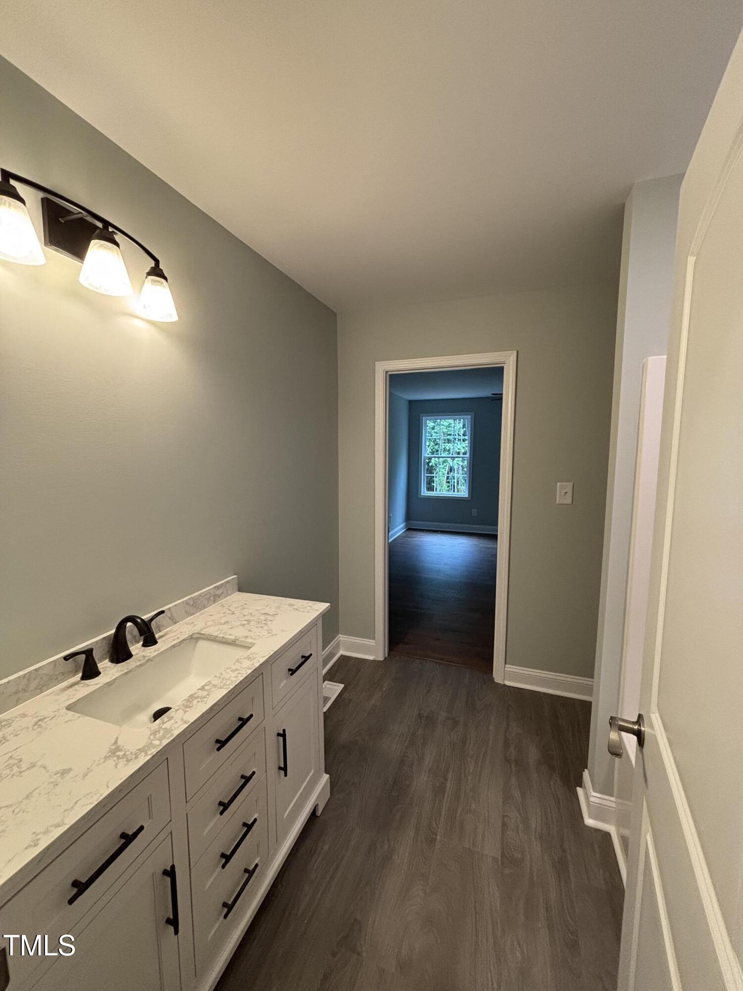 2665 Bodie Currin Road Oxford, NC 27565 - Photo 19 of 26 a bathroom with a sink vanity and mirror