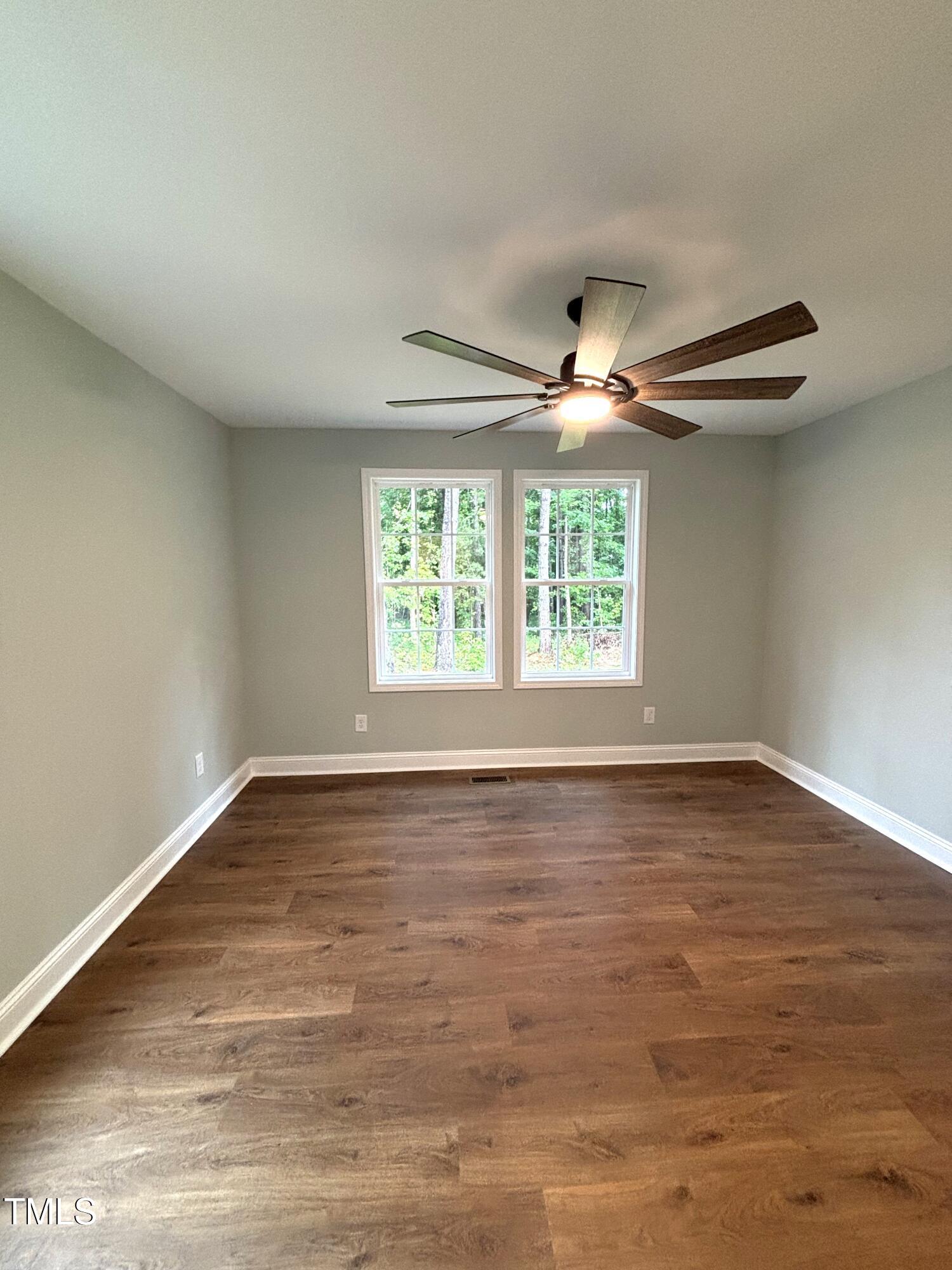 2665 Bodie Currin Road Oxford, NC 27565 - Photo 25 of 26 a view of an empty room with wooden floor and a window
