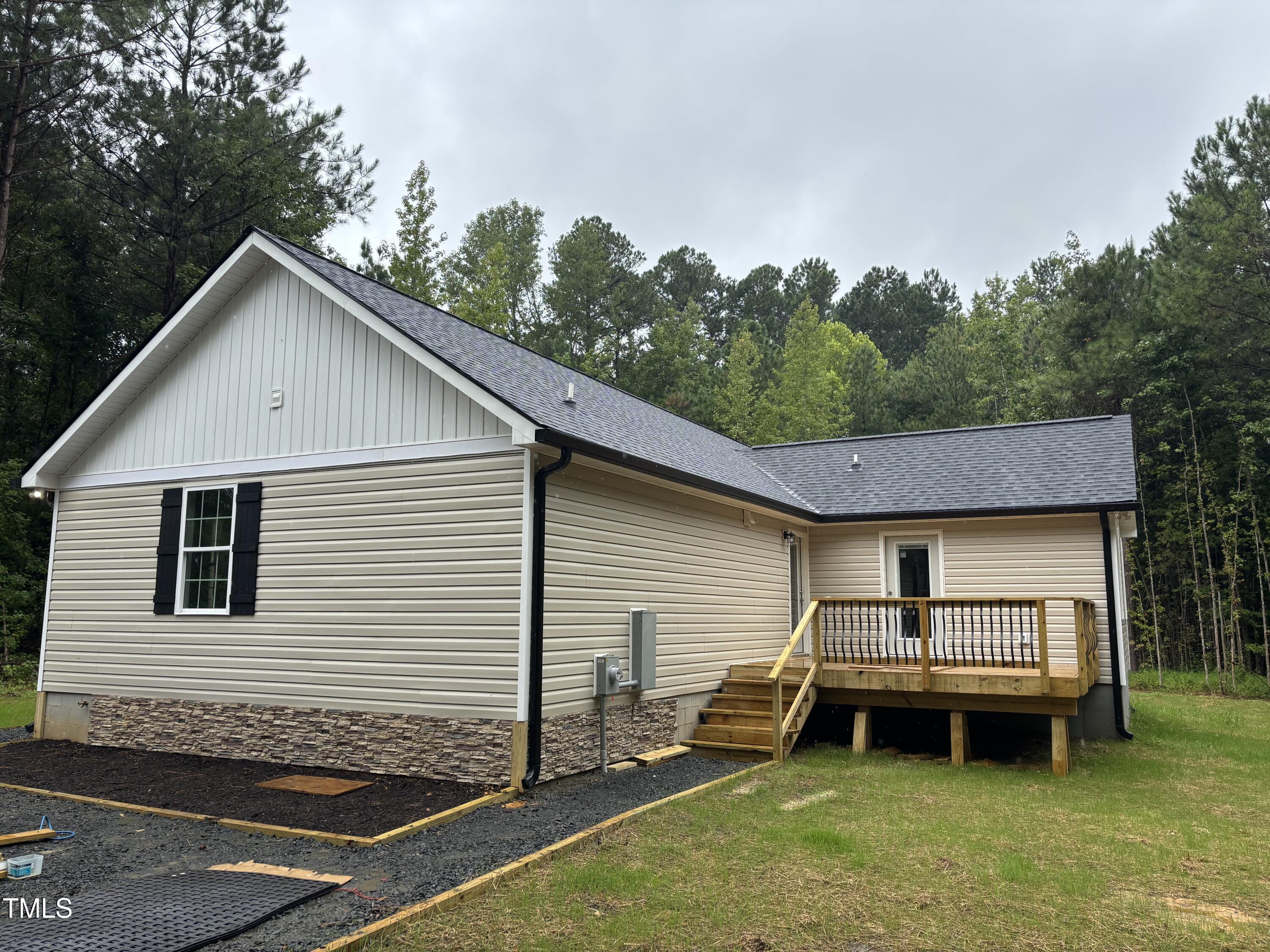 2665 Bodie Currin Road Oxford, NC 27565 - Photo 4 of 26 a backyard of a house with table and chairs