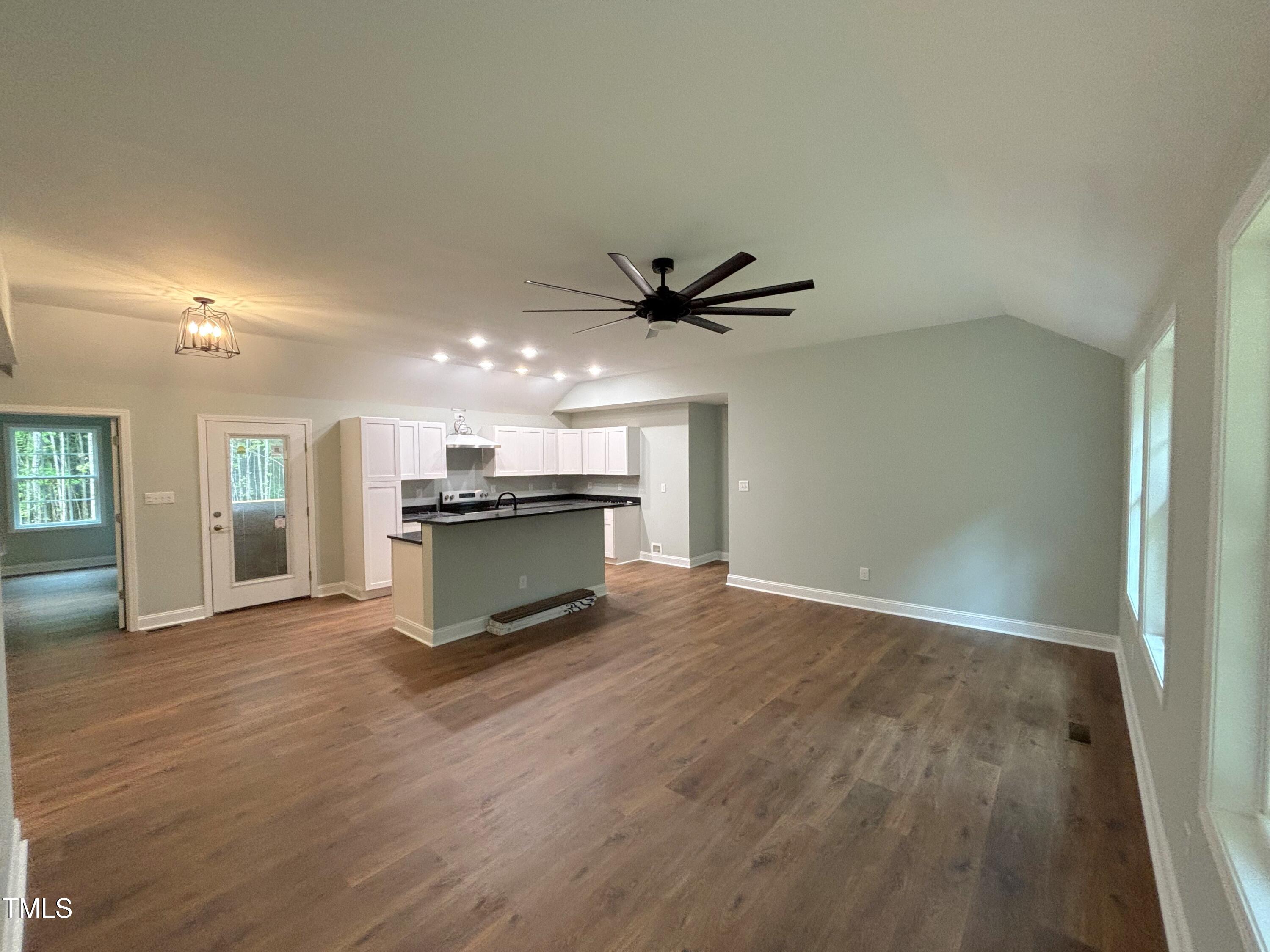 2665 Bodie Currin Road Oxford, NC 27565 - Photo 5 of 26 a view of an empty room with wooden floor and a window