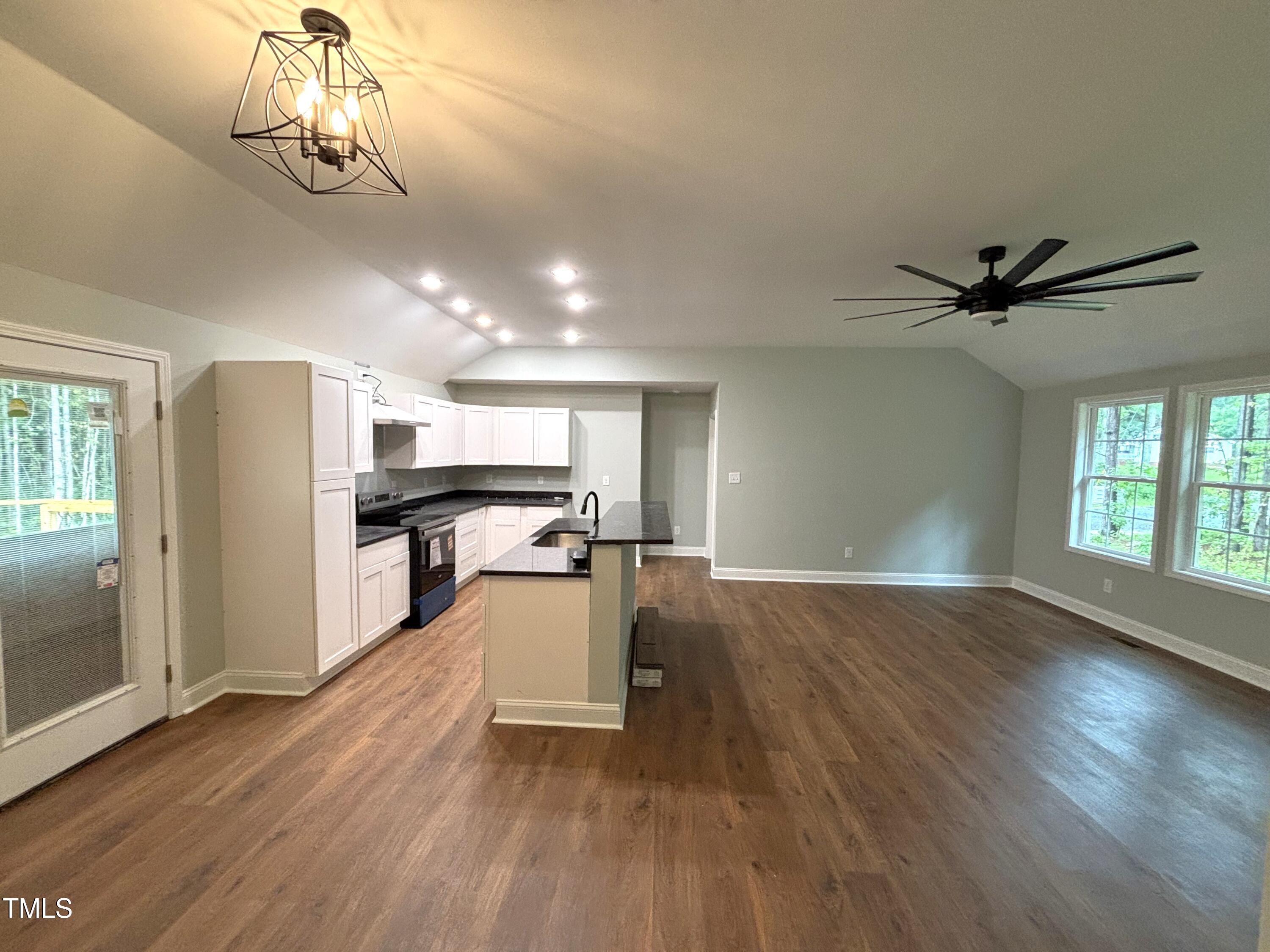 2665 Bodie Currin Road Oxford, NC 27565 - Photo 6 of 26 a view of a kitchen with wooden floor a sink a refrigerator and window